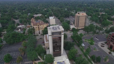 Push in pan down to left of highrise in downtown fort collins Video stock 157735898