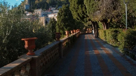 Push in panning view of the town of Taormina and the East coast of Sicily Stock Footage 122938709