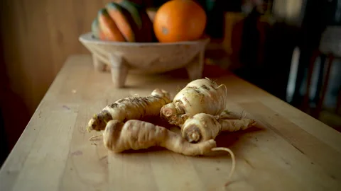 Push in of parsnips on a wooden table or cutting board Stock Footage 145743987
