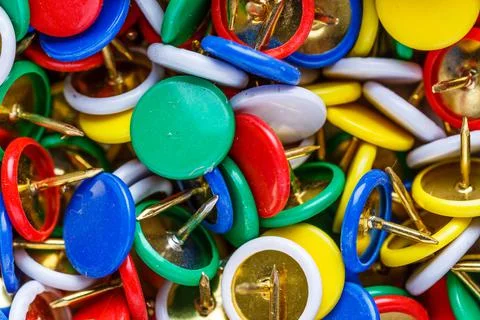 Push pins background.Set of push pins in different colors.Top view. Stock Photos