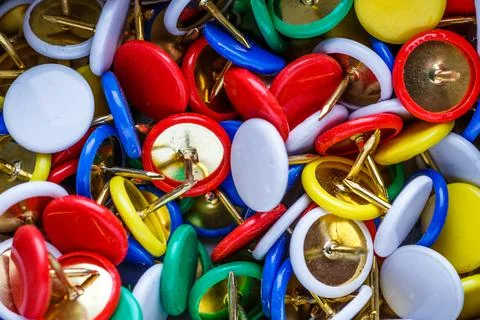 Push pins background.Set of push pins in different colors.Top view. Stock Photos