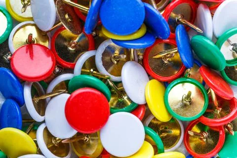 Push pins background.Set of push pins in different colors.Top view. Stock Photos