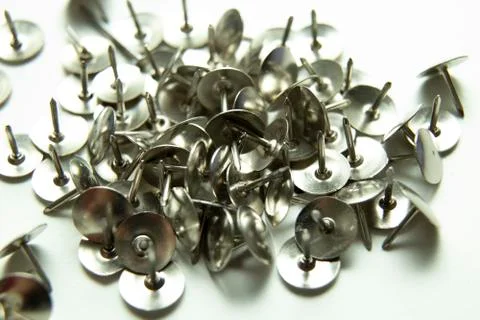 Push pins on a white background. Colored and silver buttons. Many and one. Bl Stock Photos