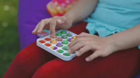 Push pop bubble fidget toys. Stress relief toys squeeze sensory toys for kids Stock Footage 194747346