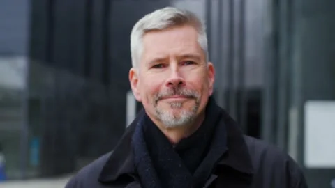 Push-in portrait of handsome middle aged old man outdoors smiling at camera. Stock Footage 165209268