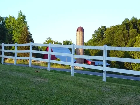 Push in on red barn over hill Stock Footage 76444372