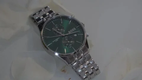 Push In Shot of BOSS Chronograph Watch Green Dial on White Surface Stock Footage 334843508