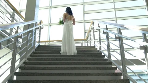 Push-in shot of a bride standing on stairs 動画素材 76231820