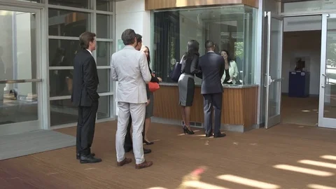 Push-in shot of business people checking in 動画素材 76232066