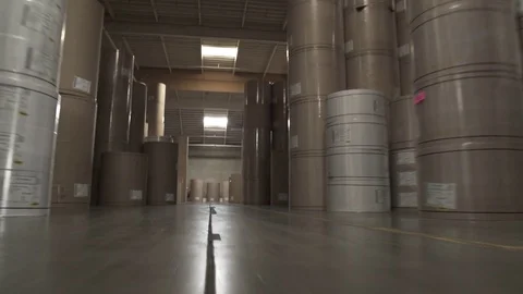 Push-in shot of cardboard tubes in a warehouse 動画素材 76534548