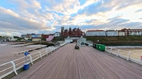 Push in shot down the Victorian pier towards the coastal town of Cromer Stock-Footage 255534338