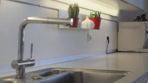 Push In Shot Indoor Kitchen Sink Faucet White Backsplash Plants Vídeo Stock 334419971