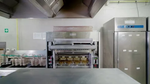 Push-in shot of metallic appliances in fast food restaurant kitchen Stock Footage 236970926