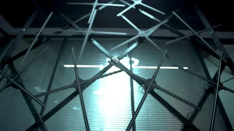 A push in shot of multiple huge holographic fans placed on a black structure Stock Footage 96225484
