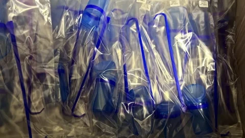 Push In Shot Reveals Packaged Blue Plastic Dairy Equipment Wrapped in Bags Stock Footage 341539384