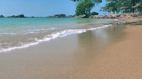 Push in shot. Sea waves moving on sand beach in suny day. Stockbeeldmateriaal 120883206