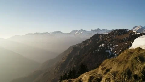 Push In Shot Of Small Amount of Snow on Top of The Hill Surrounded With Alps. Stock Footage 168253289