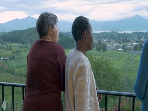 Push in stabilized shot of three female tourists over 60 talking at an overlook Stock Footage 80977261