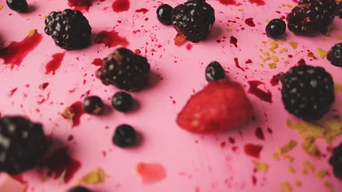 Push in into a table of berries in a pink background Stock Footage 140041894