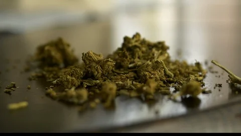 Push in to a tight shot of marijuana bud on a table in a home. Stock Footage 123241516