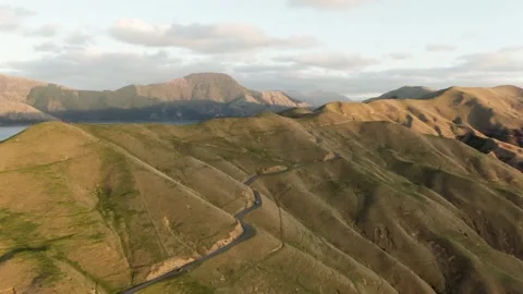 Push tilt in of car driving on mountain road Stock Footage 133854949