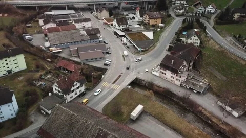 Push in, tilt down aerial shot on a busy intersection in European town. Stock Footage 149883987