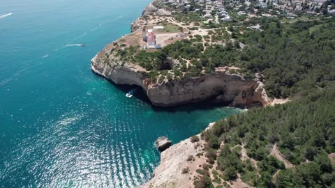 Push towards the Farol de Alfanzina lighthouse in Portugal as boat emerges .. Stock Footage 310460217