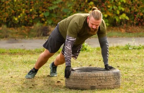 Push-ups on the tires. Stock Photos