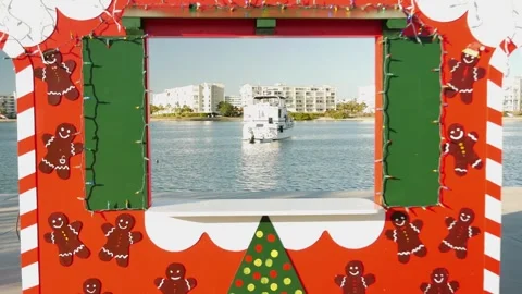 Push in Wide Framed view through a red, white and green Christmas photo booth. Stock Footage 295009688