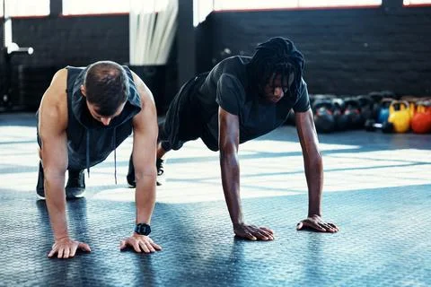 Push up, workout and personal trainer with men in gym for fitness, health a.. Stock Photos