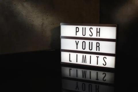 Push your limits motivational message on a light box Stock Photos
