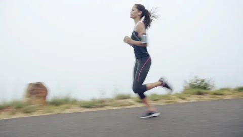 Push yourself to do better. 4k video footage of a woman enjoying a daytime jog. 스톡 동영상 200844735