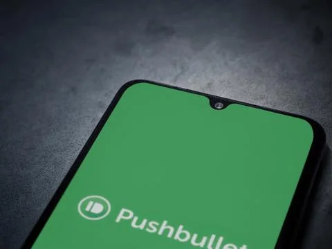 Pushbullet app launch screen on smartphone on dark marble stone background Stock Photos