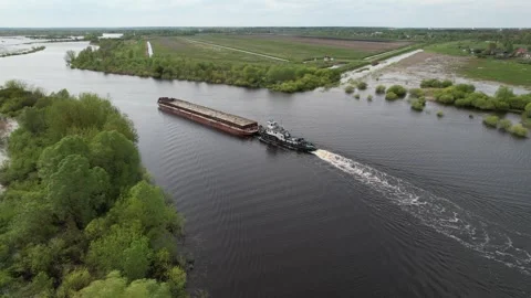 The pusher tug pushes the barge down the river. Pripyat River. Stock Footage 240379705