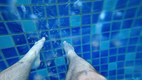 Pushes off from the side of the pool with his feet Stock-Footage 192312579