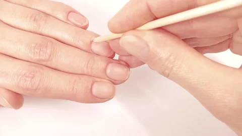 Pushing back nails cuticles with an orange stick and nails massage Stock Footage 256973793