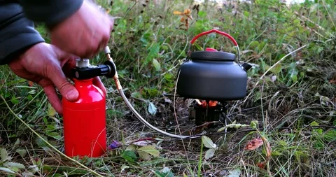Pushing the baloon to kindle a fire of camping gas burner. Stock Footage 91169295