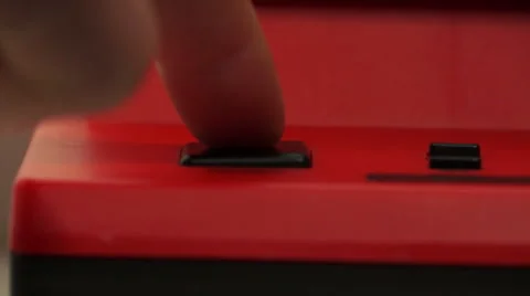 Pushing black button on red video game console Stock Footage 67425992
