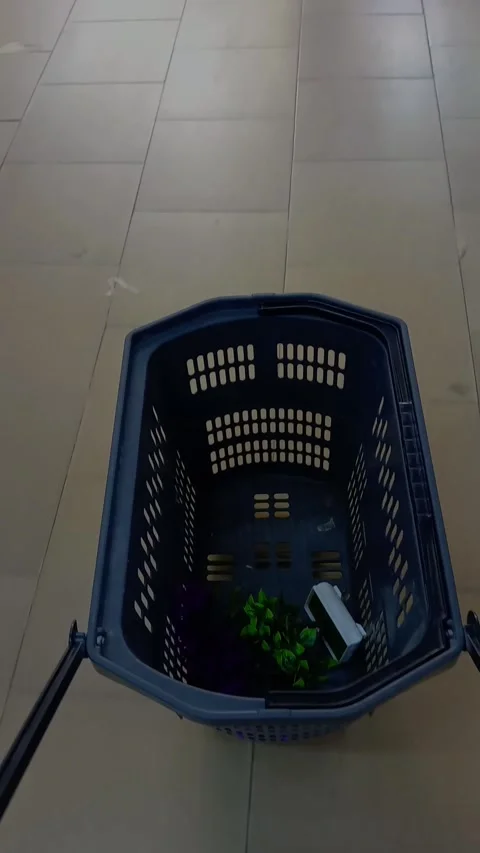 Pushing blue-black plastic basket trolley on tiled floor. Stock Footage 312485405