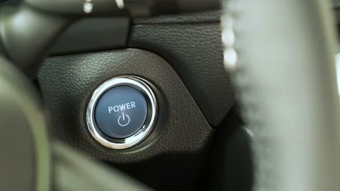 Pushing blue  power ignition button to start keyless ignition  on  car engine Stock Footage 118114987