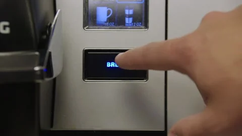 Pushing brew button on coffee maker Stock-Footage 139719694