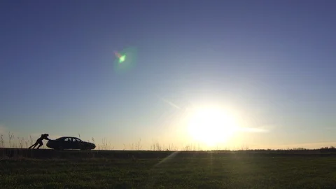 Pushing a broken car Stock Footage 89509204