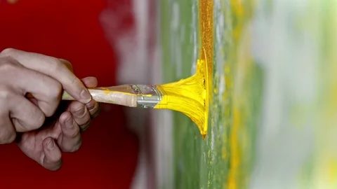 Pushing the brush covered in yellow paint into the wall - interior design Stock Footage 123488531