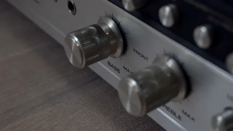 Pushing buttons and twisting knobs on an old amplifier. 動画素材 138700843