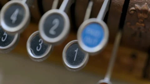 Pushing down the no sale key or latch on an antique cash register Stock Footage 235133399