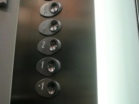 Pushing the elevator button labeled with the number one Stock Footage 79979993