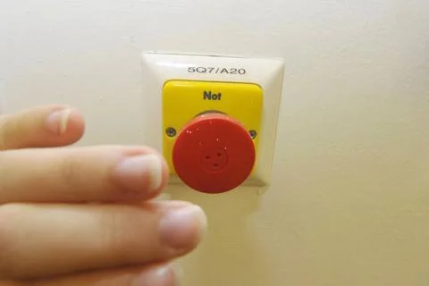 Pushing the emergency stop power switch, safety at the workplace pushing t... Fotos Stock