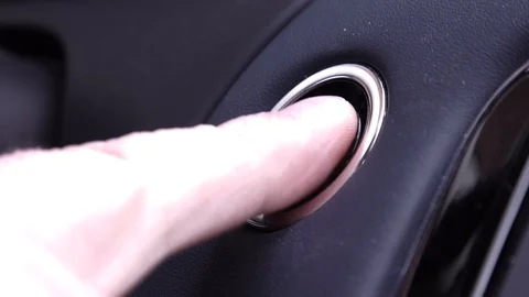 Pushing engine start stop button from a modern car interior. Stock Footage 100843563