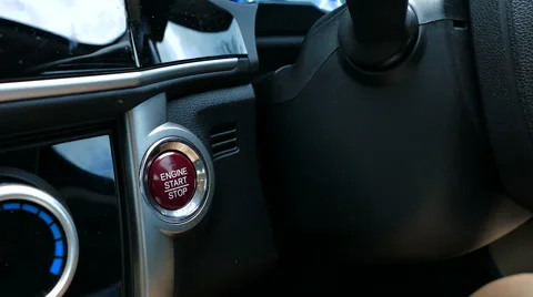 Pushing the keyless start button on a car's dashboard. Stock Footage 68743395