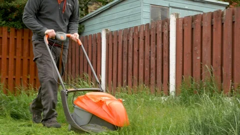 Pushing lawnmower though thick grass Video stock 114995806